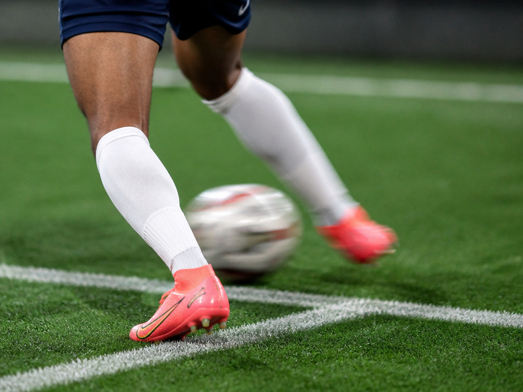 Close-up of a footballer performing the deceptive Cruyff turn maneuver.